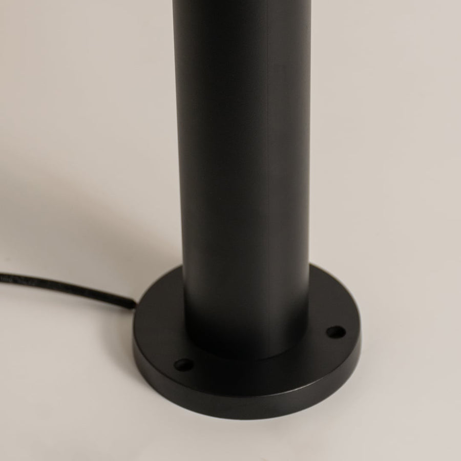 A detailed closeup focused on the upper section of the bollard light showing the metal cap transparent glass edges and inner bulb socket structure for product clarity.