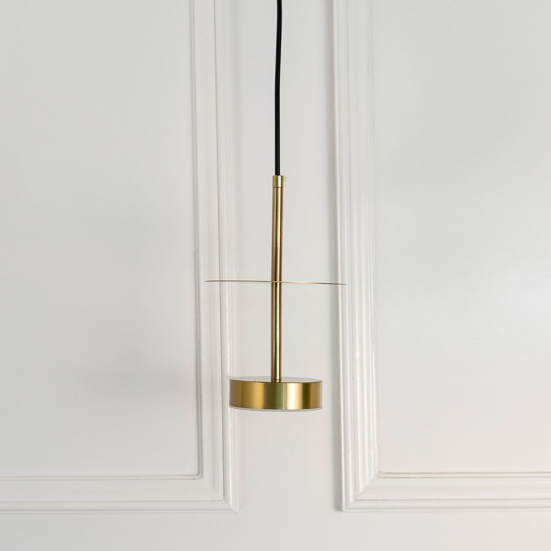 Gold metal pendant light with sleek cylindrical design designed for stylish living spaces.