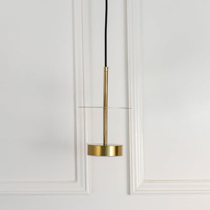 Gold metal pendant light with sleek cylindrical design designed for stylish living spaces.