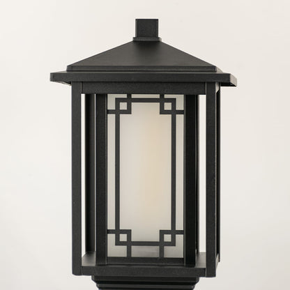 Closeup of black outdoor gate light with geometric glass panels for luxury exterior decor styling.