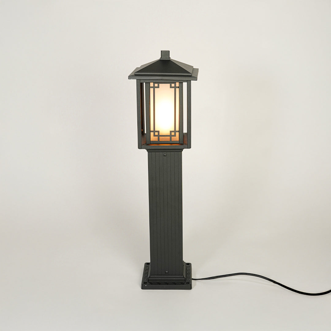 Black outdoor garden pole light with classic lantern design on neutral background ideal for pathway lawn or driveway lighting.