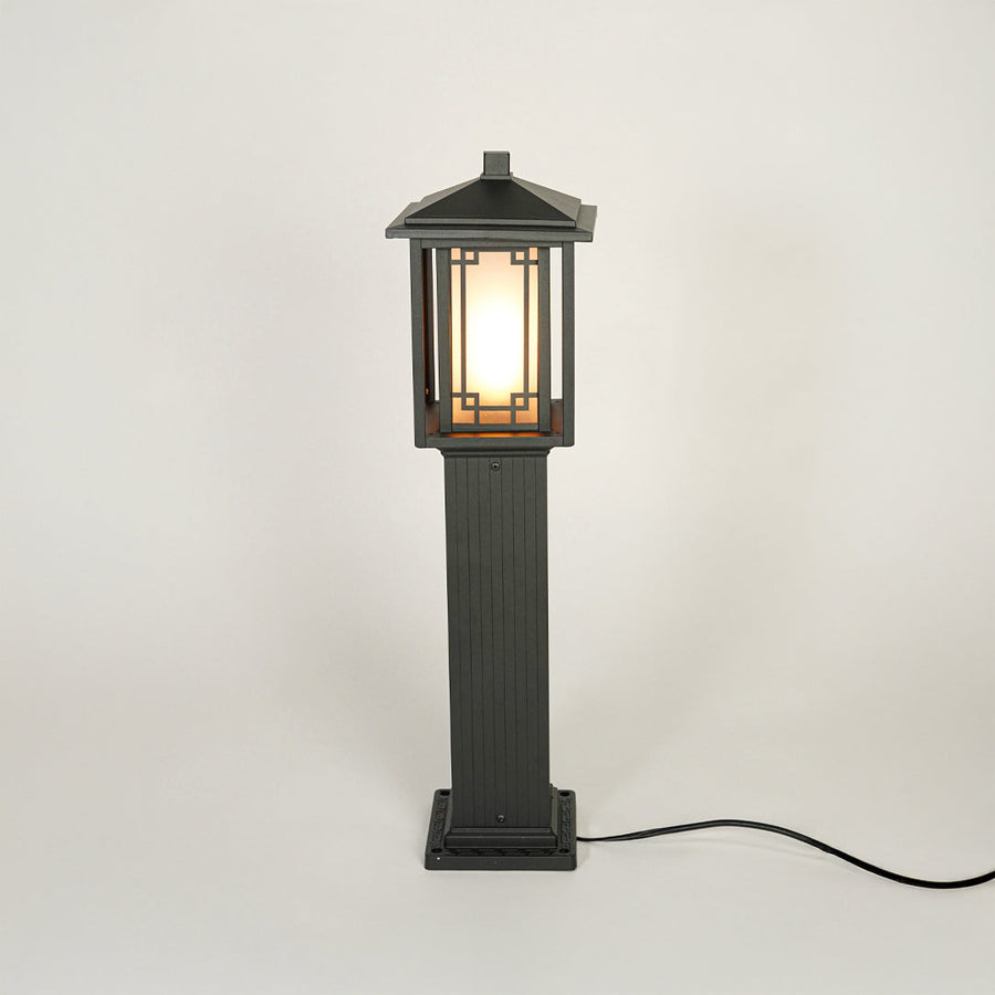 Black outdoor garden pole light with classic lantern design on neutral background ideal for pathway lawn or driveway lighting.