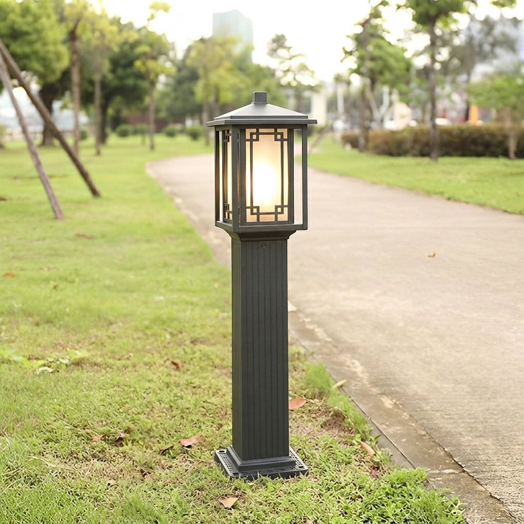 Outdoor garden pole light with matching bronze lantern design installed along pathway ideal for cohesive landscape lighting setup.

