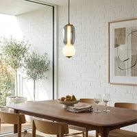 Mixed glass pendant lights creating cozy ambience above the kitchen island in contemporary interiors.