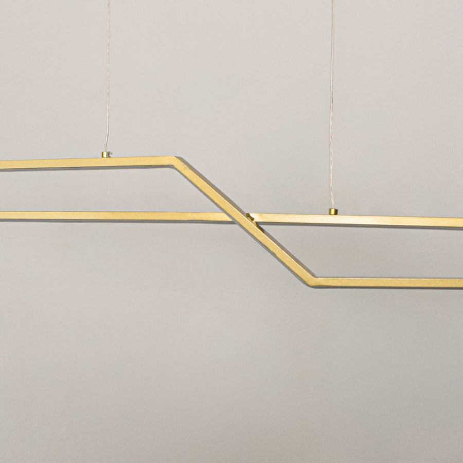 Geometric gold metal chandelier closeup highlighting angular linear design and suspended structure for contemporary ceiling lighting style.