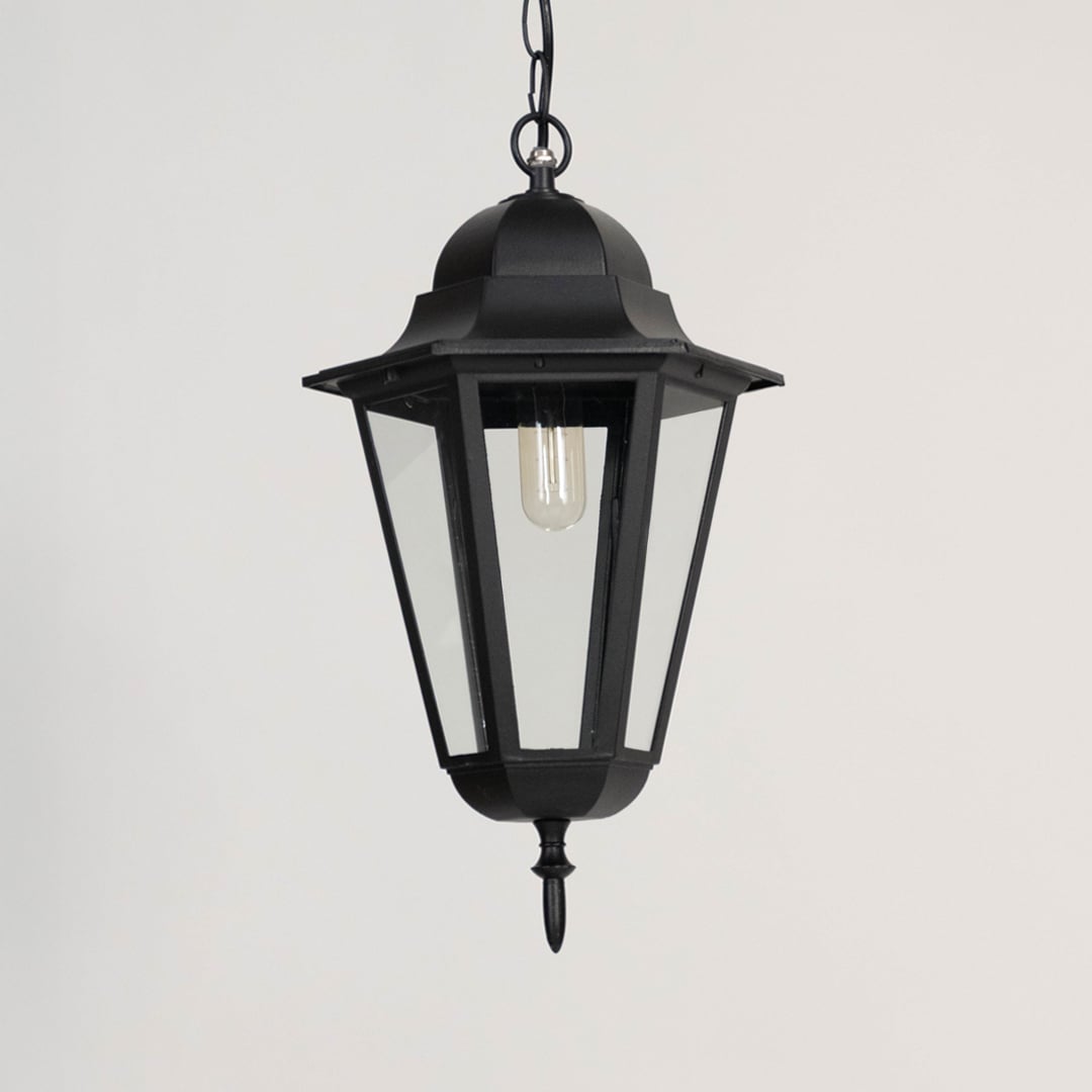 Black outdoor hanging lantern displayed off on white background showing elegant geometric metal design.