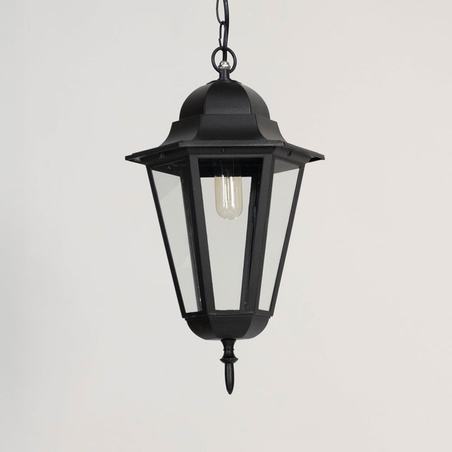Black outdoor hanging lantern displayed off on white background showing elegant geometric metal design.