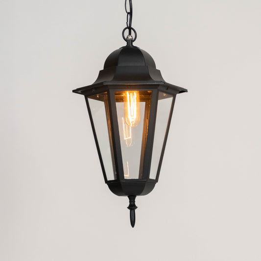 Black metal hanging lantern light with warm glow and clear glass panels for elegant outdoor decor.