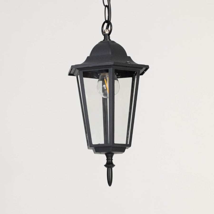 Contemporary black metal hanging lantern light with clear glass panels for stylish outdoor lighting decor.