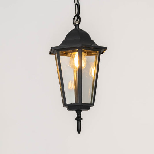 Modern black metal hanging lantern light with warm glow for elegant balcony and porch decor.