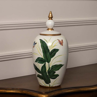 Handcrafted white ceramic jar with lush green botanical design ideal for luxury modern home decor styling.