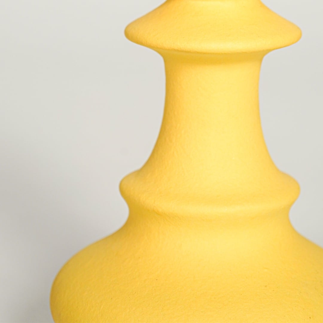 Matte yellow ceramic chess pawn decor showing rounded top curved base and smooth texture suitable for shelf or table display.