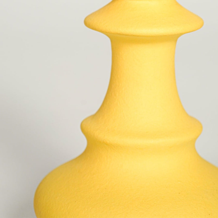 Matte yellow ceramic chess pawn decor showing rounded top curved base and smooth texture suitable for shelf or table display.