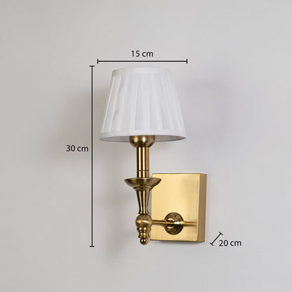 Gold metal wall sconce with white pleated shade shown with 30 cm height and 15 cm width for accurate size detail.