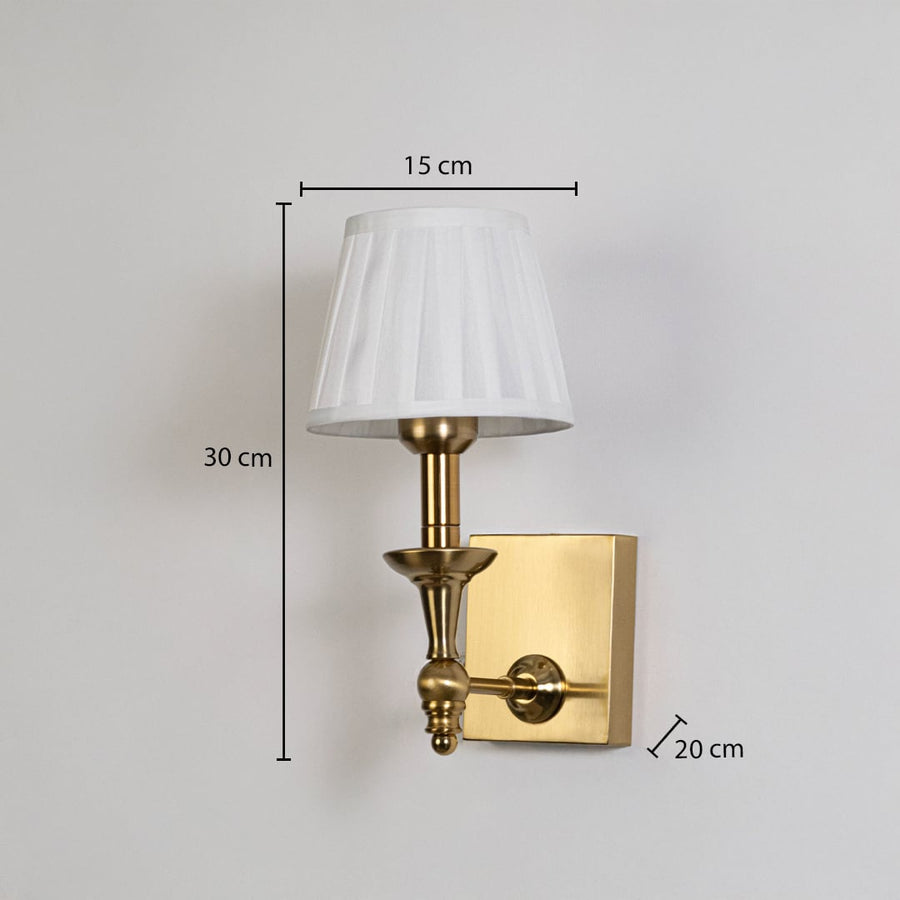 Gold metal wall sconce with white pleated shade shown with 30 cm height and 15 cm width for accurate size detail.