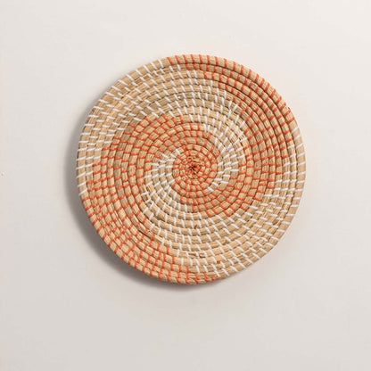 Natural and terracotta woven decorative wall basket with spiral design for artistic wall styling and modern home decor.