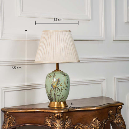 Green floral table lamp with beige pleated shade measuring 55 cm in height and 32 cm in width ideal for bedroom or living room.