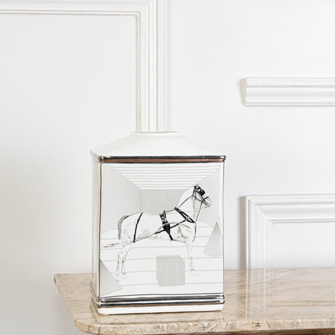 White ceramic jar with black galloping horse artwork in an angled view ideal for artistic décor and modern living room styling.