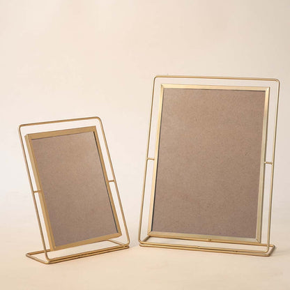 Set of gold metal photo frames with elegant minimalist design for contemporary tabletop styling and home decor.