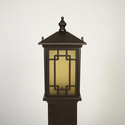 Close view of outdoor lantern pole light with warm glass glow showcasing durable weather resistant exterior lighting design.

