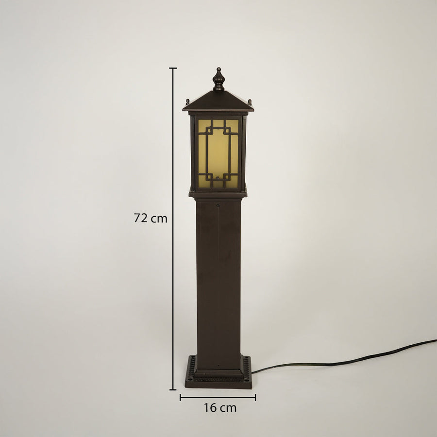 Outdoor pillar light with brown metal body and warm glass diffuser on neutral background 72 cm height 16 cm width ideal for garden pathway lighting.