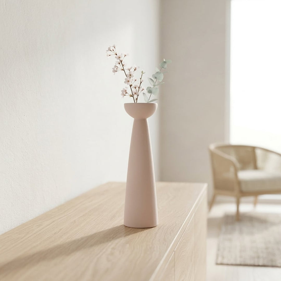 Pink ceramic tall flower vase placed on console table modern decorative vase for living room corner home decor styling.
