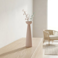Pink ceramic tall flower vase placed on console table modern decorative vase for living room corner home decor styling.