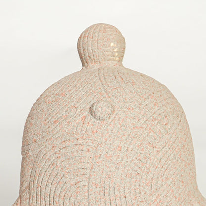 Close up view abstract ceramic sculpture showing carved circular texture and organic curved form modern art decor piece.