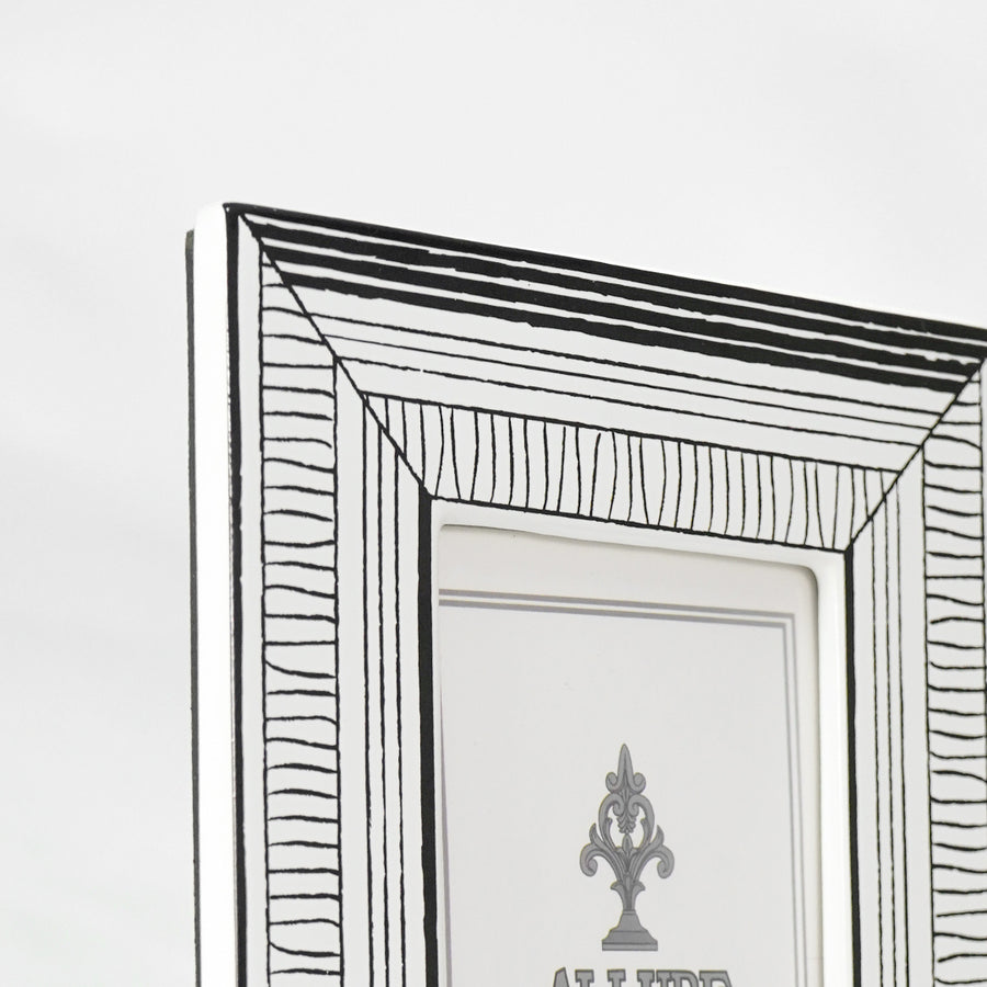 Closeup image of black metal photo frame for modern tabletop decor styling with artistic geometric detailing.
