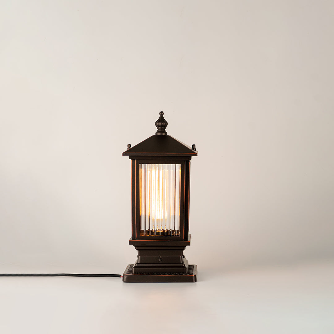 Black outdoor gate light with warm glowing bulb for elegant modern exterior decor styling use.