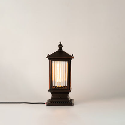 Black outdoor gate light with warm glowing bulb for elegant modern exterior decor styling use.