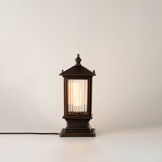 Black outdoor gate light with warm glowing bulb for elegant modern exterior decor styling use.