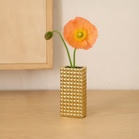 Gold textured ceramic vase styled on a soft backdrop adding a modern metallic accent for living room shelves consoles or table decor.