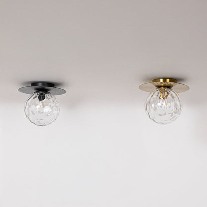 Black and gold ceiling lights with textured glass globes in off mode displayed on white background for home interior decor.