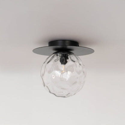 Black ceiling light with textured glass globe in off mode displayed on clean white background for modern ceiling decor.