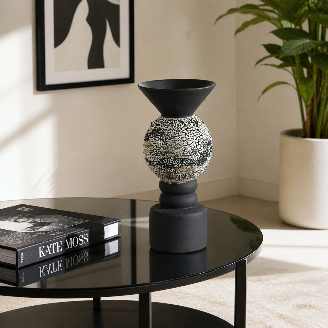 Black textured metal candle holder placed on side table for stylish contemporary home decor styling.