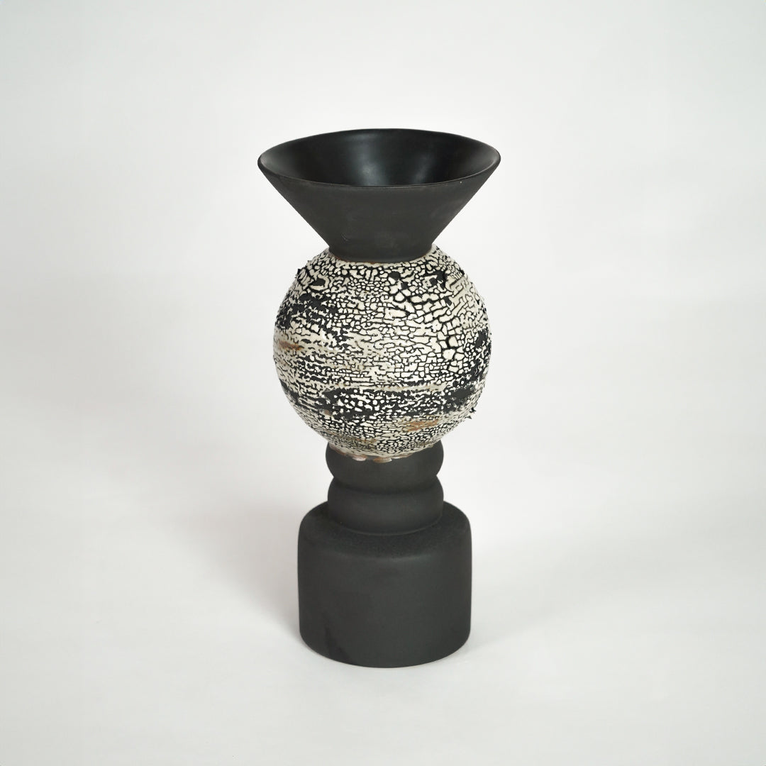 Black ceramic vase with textured silver detail for modern shelf placement and luxury indoor decor styling accent.
