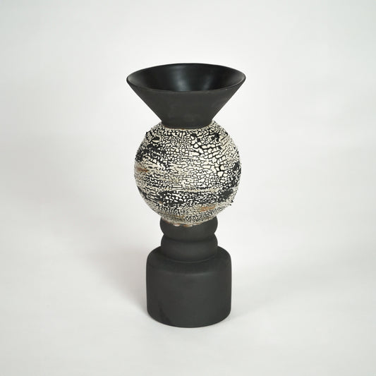 Black ceramic vase with textured silver detail for modern shelf placement and luxury indoor decor styling accent.