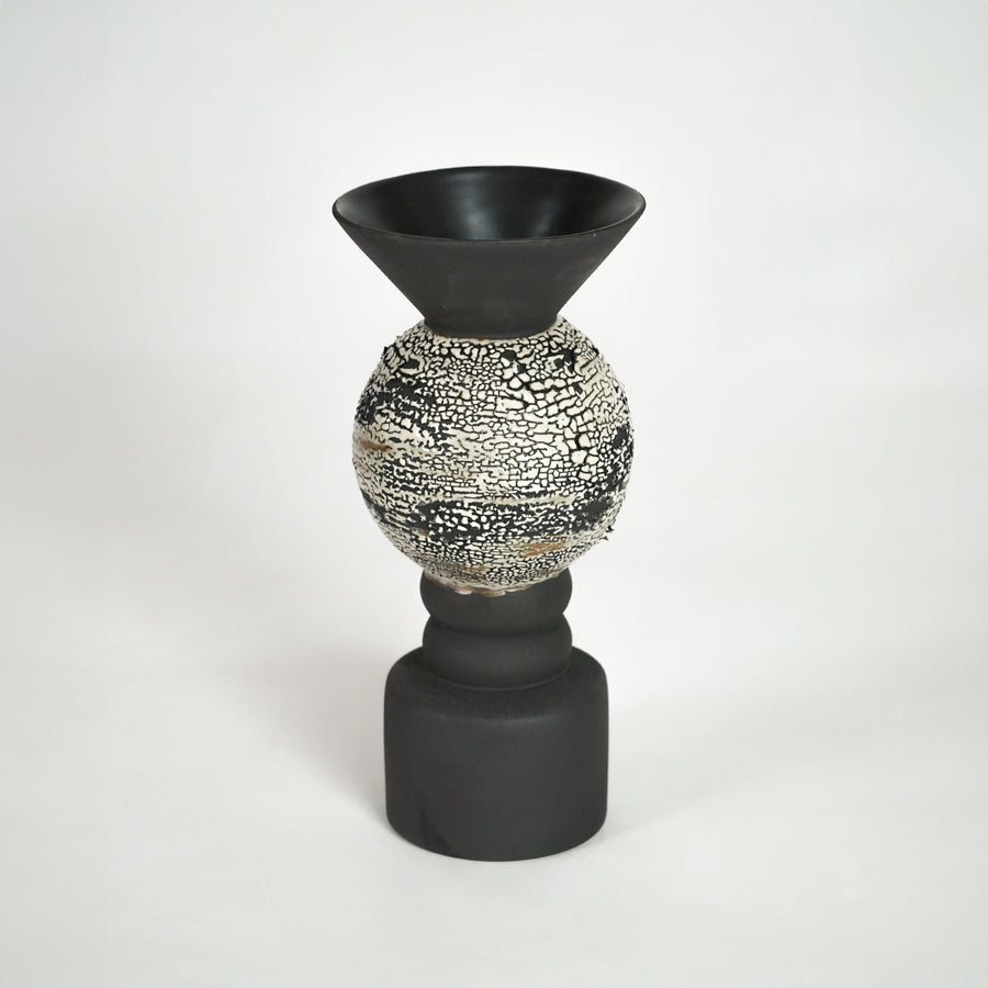 Black ceramic vase with textured silver detail for modern shelf placement and luxury indoor decor styling accent.