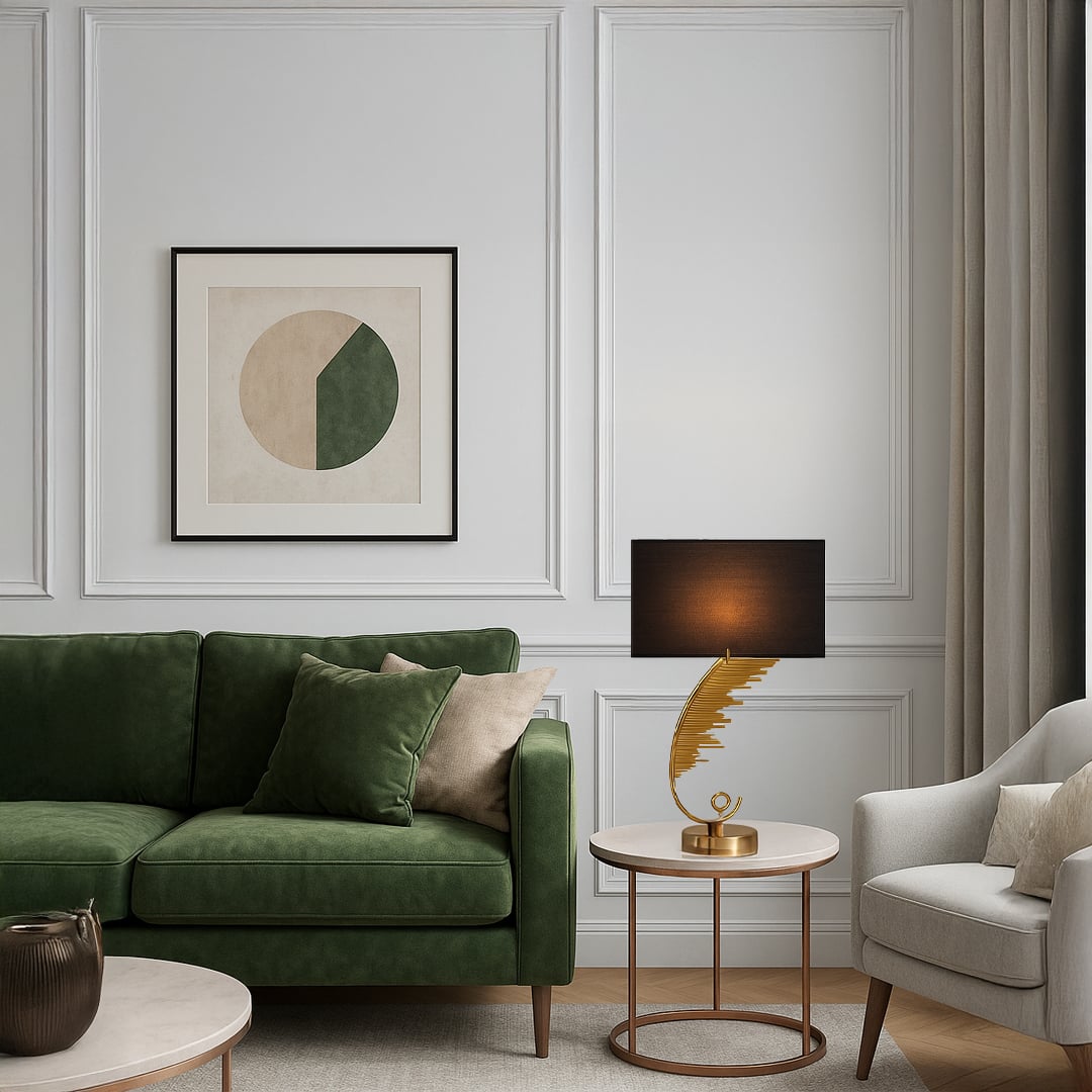 Gold sculpted table lamp with a curved artistic base and black rectangular shade placed on a round side table adding warm ambient lighting to a modern living room.