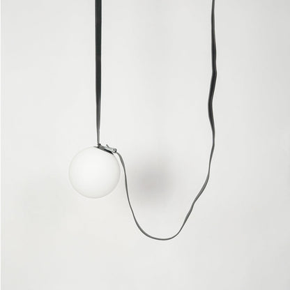 White globe glass pendant light with exposed black cord creating a minimalist contemporary look.