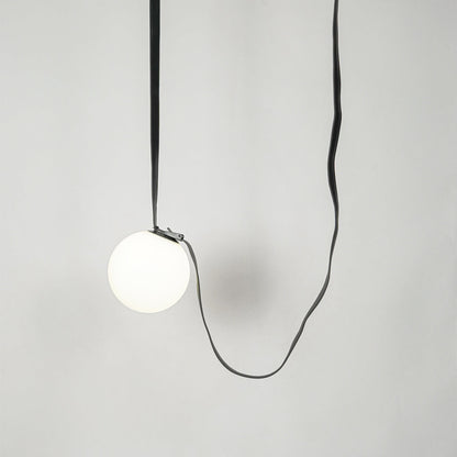 White glass pendant light with black fabric cord designed for stylish modern home decor spaces.