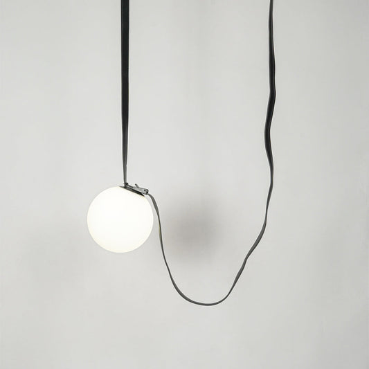 White glass pendant light with black fabric cord designed for stylish modern home decor spaces.