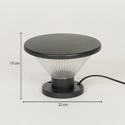 Contemporary outdoor surface light with black metal top and textured glass diffuser on neutral background 15 cm height 22 cm width ideal for garden or pathway lighting.


