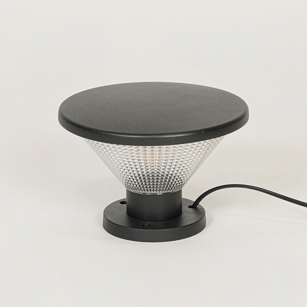 Minimal outdoor pillar light with black metal frame and glass diffuser on clean background perfect for contemporary landscape lighting.