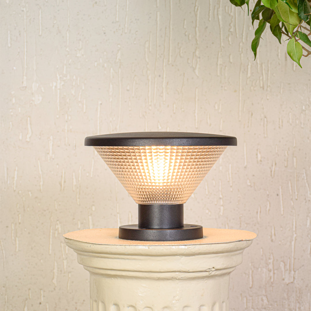 Contemporary outdoor pillar light with glowing textured glass shade mounted on exterior wall ideal for modern garden lighting.

