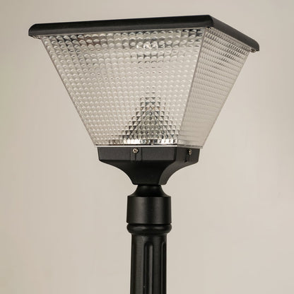 Closeup of black solar outdoor street light with textured glass shade for elegant exterior decor use.