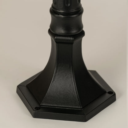 Closeup of black outdoor street light base with modern metal finish for exterior decor styling use.