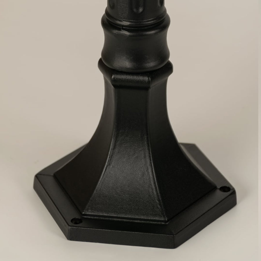Closeup of black outdoor street light base with modern metal finish for exterior decor styling use.