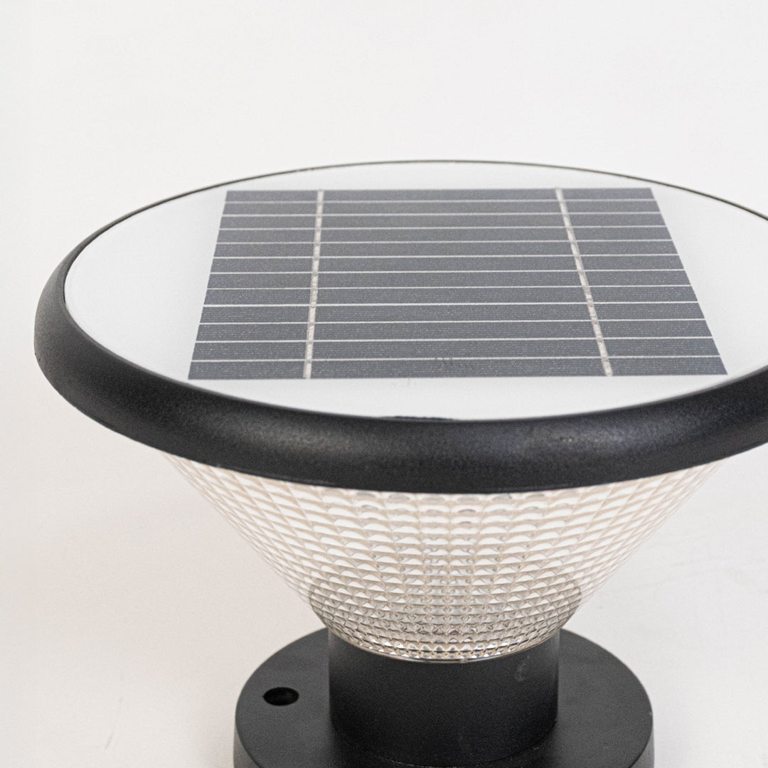 Closeup of black solar outdoor gate light with top solar panel for smart exterior decor styling.